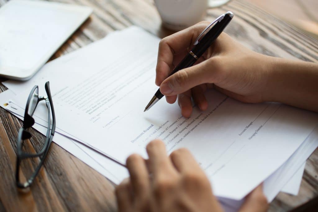 businessman examining papers table